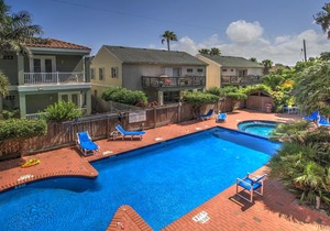 Spacious oasis near the beach with a private balcony, pool, and hot tub in South Padre Island