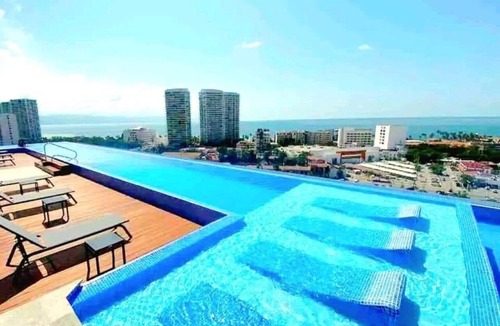 North Hotel Zone Condo | Stunning rooftop infinity pool minutes from the beach