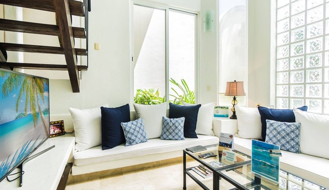 2 Bedroom condo with a 2 level high Living Room by BRIC at the Royal Palms